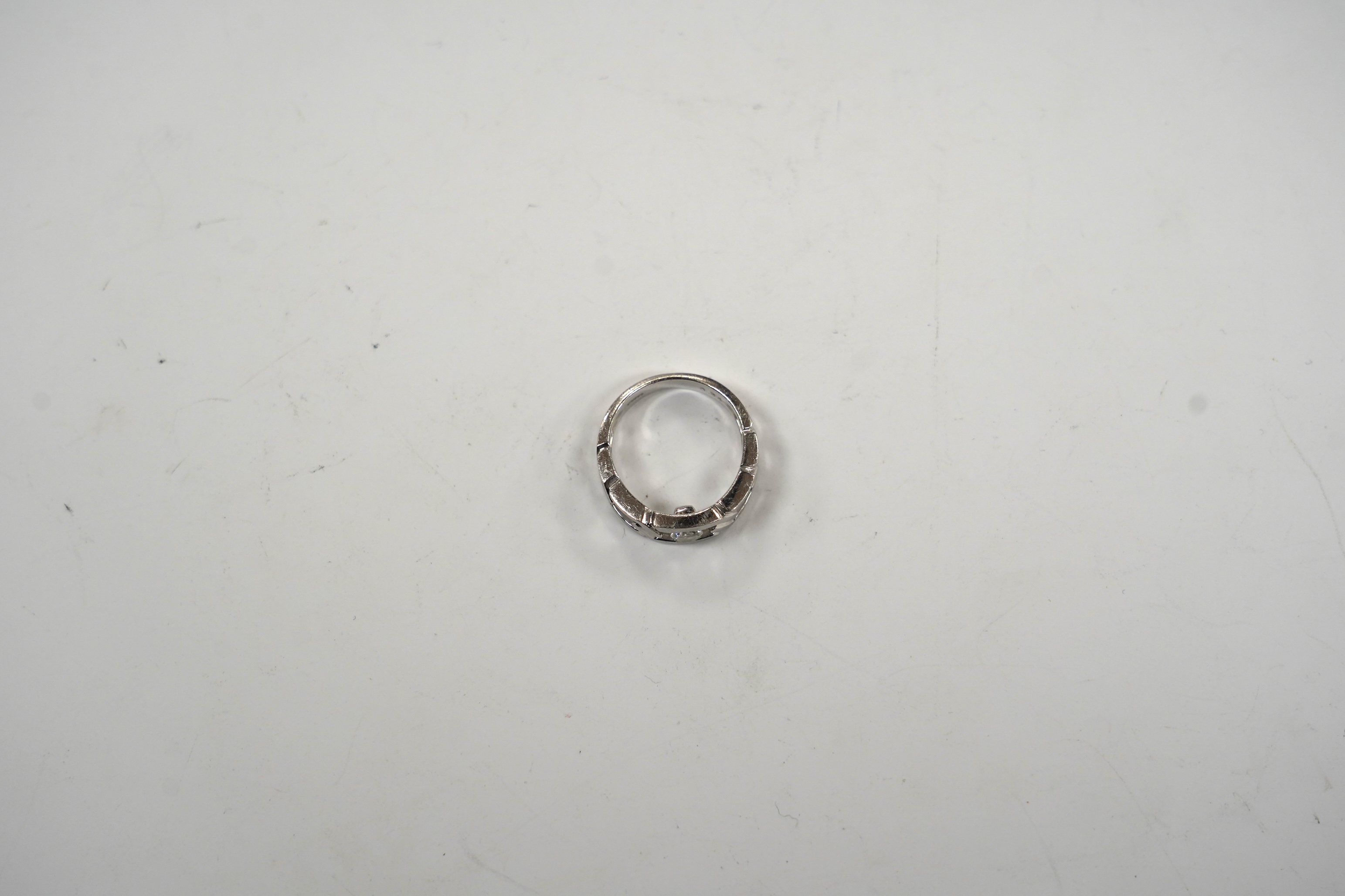 A modern pierced white metal (stamped PT900) and solitaire diamond set ring, size K, gross weight 6.7 grams.